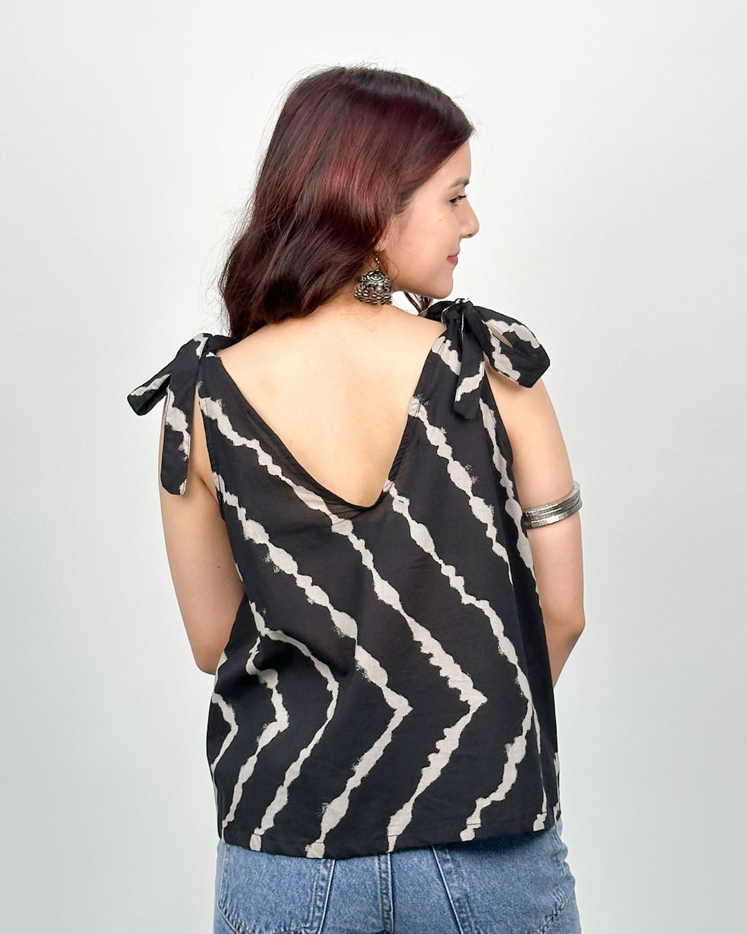 Black Nina Shoulder Tie Top - black printed sleeveless top with white pattern and shoulder ties, worn by model.