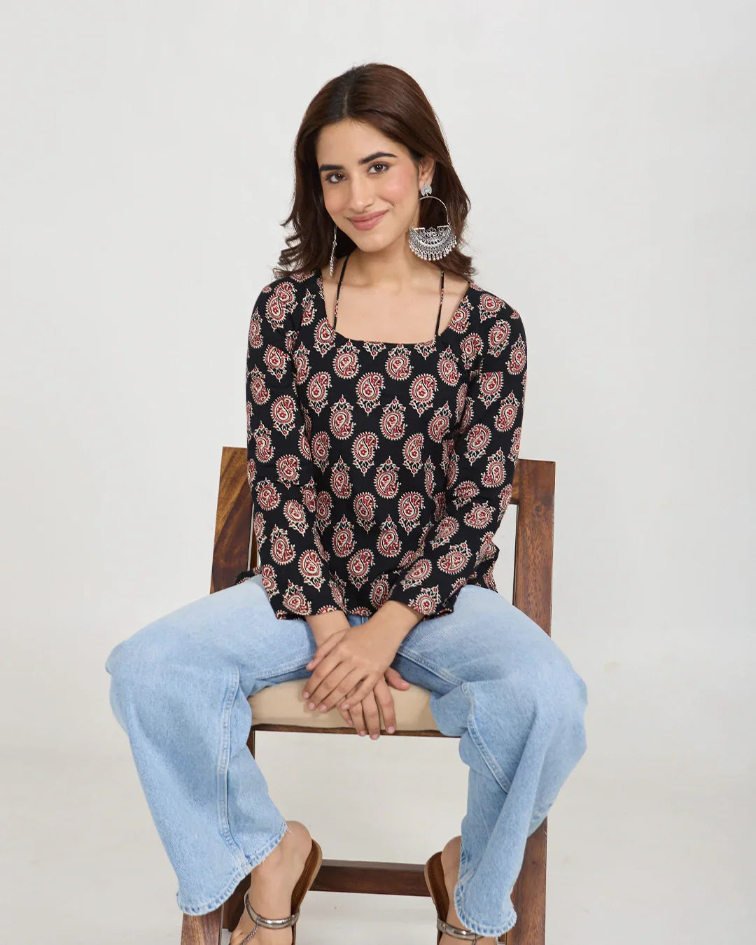 Black Noor Short Kurti - black printed long-sleeve kurti worn by model, paired with light-wash jeans