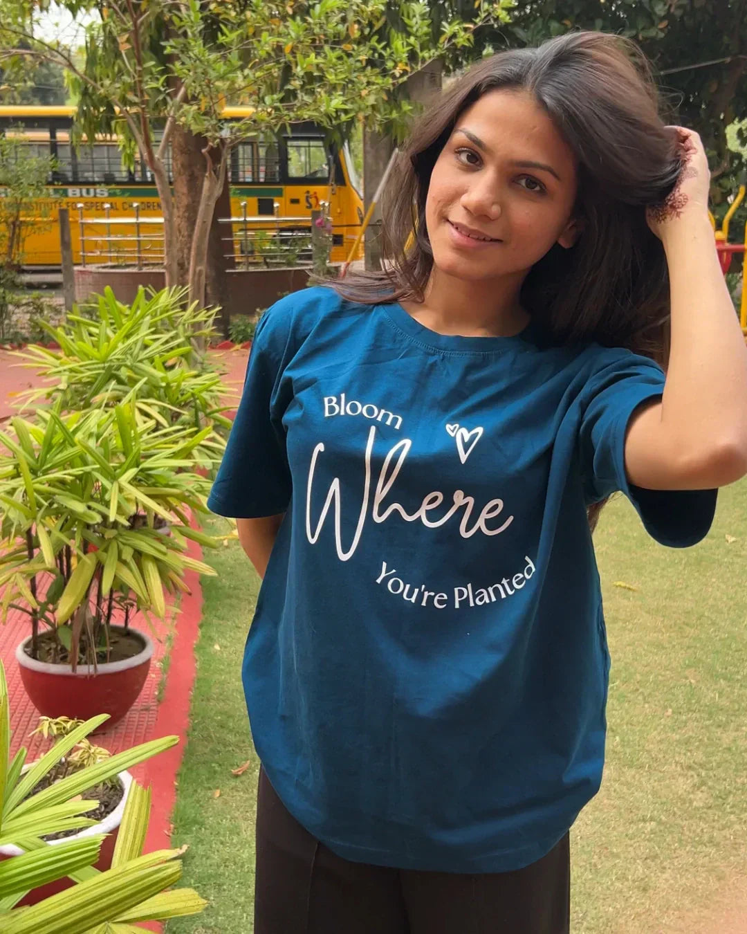 Bloom Where You Are Planted Oversized T-Shirt in teal with white graphic text, worn by model