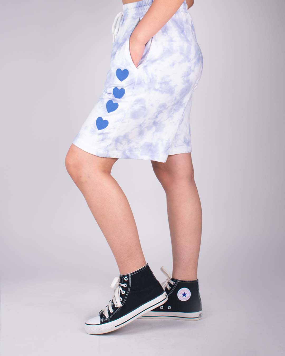 Blue Tie Dye Bermuda Shorts – light blue/white tie-dye shorts with blue heart prints, worn by model