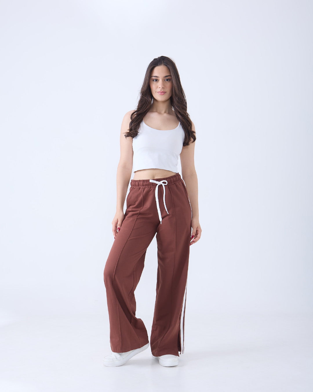 Brown Gossip Pants – brown wide-leg jogpant with white drawstring, worn by model