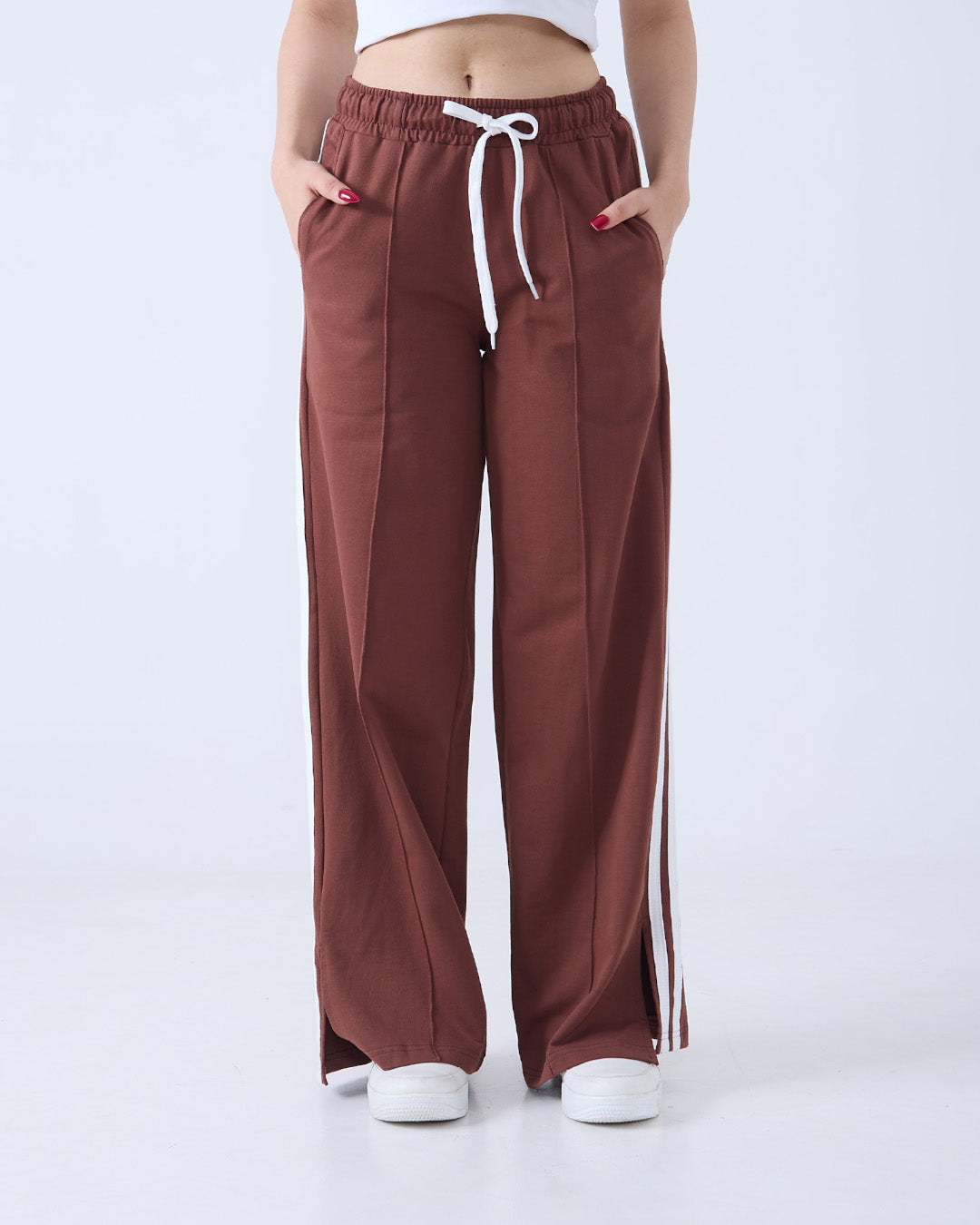 Brown Gossip Pants – DKY BW JogPant, wide-leg joggers with white drawstring and side piping, worn by model