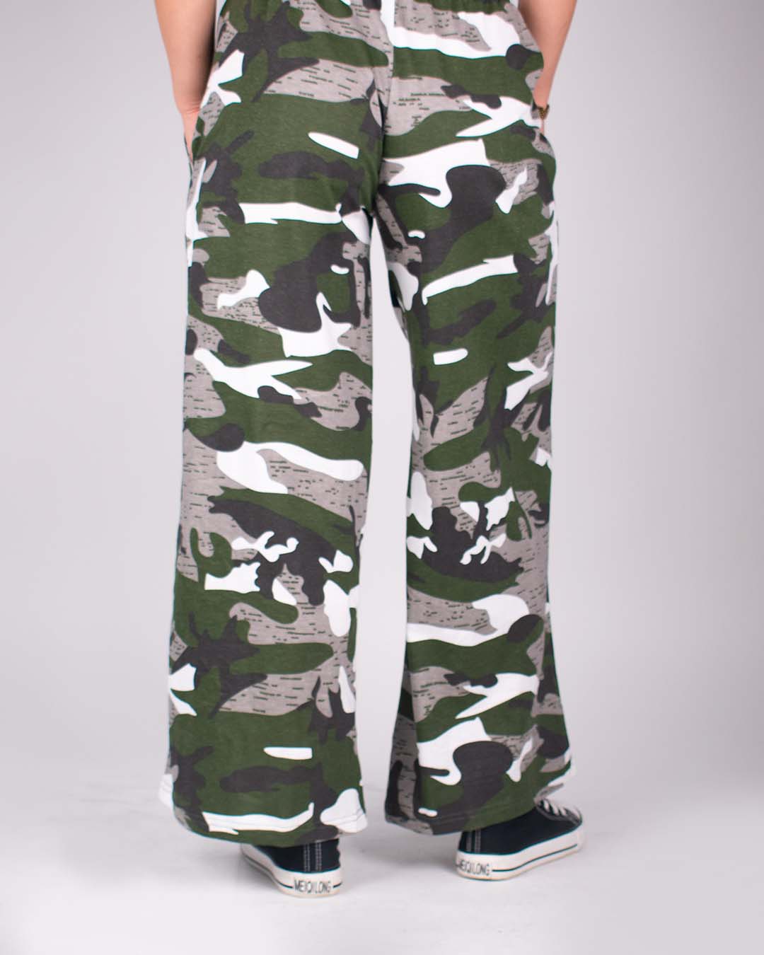 Camo Pajama by DKY – green camouflage wide-leg pants worn by model.