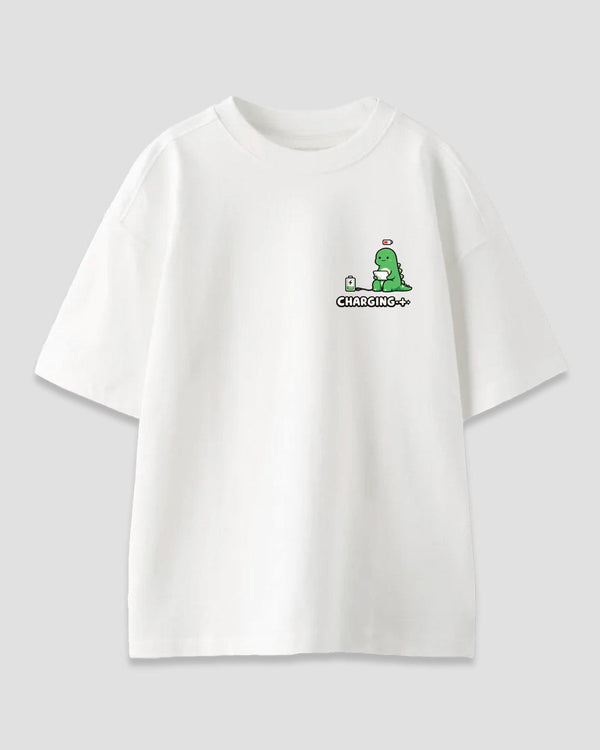 Charging Oversized T-Shirt – white OS graphic tee with a small green dinosaur charging a battery on the chest