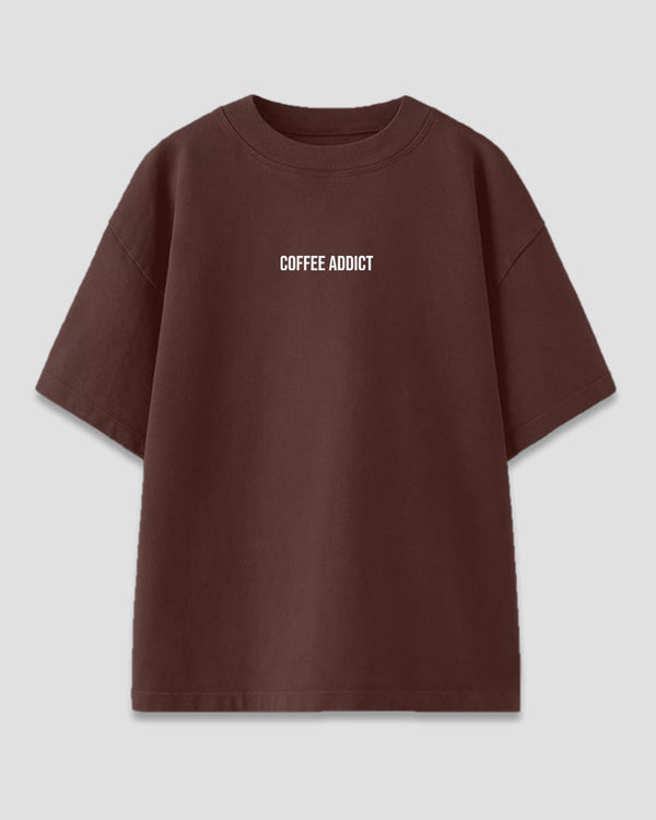 Coffee Addict Oversized T-Shirt – brown oversized tee with white graphic text, shown in flat lay