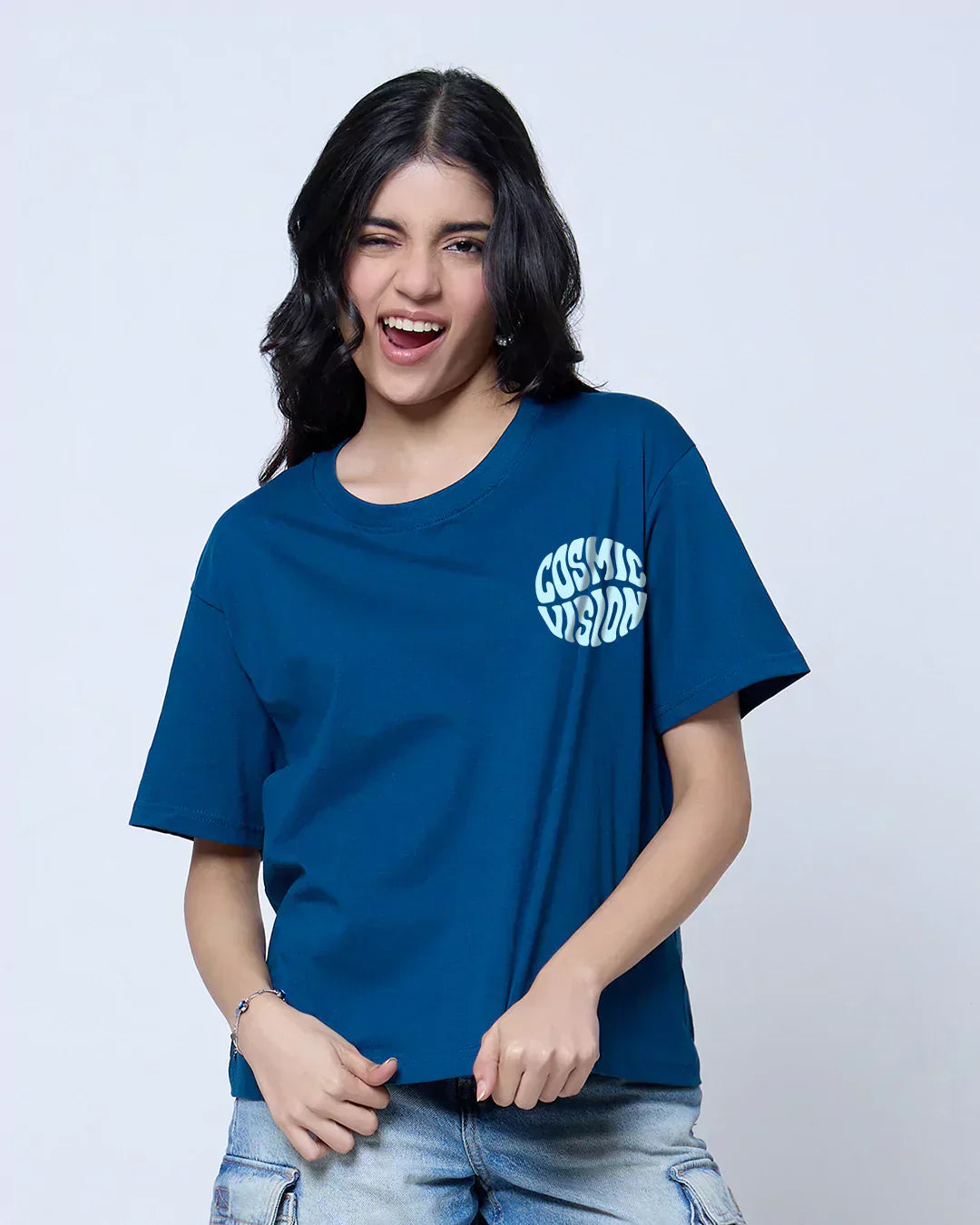 Cosmic Vision Boxy Oversize T-Shirt – teal blue boxy tee with Cosmic Vision circular logo, worn by model