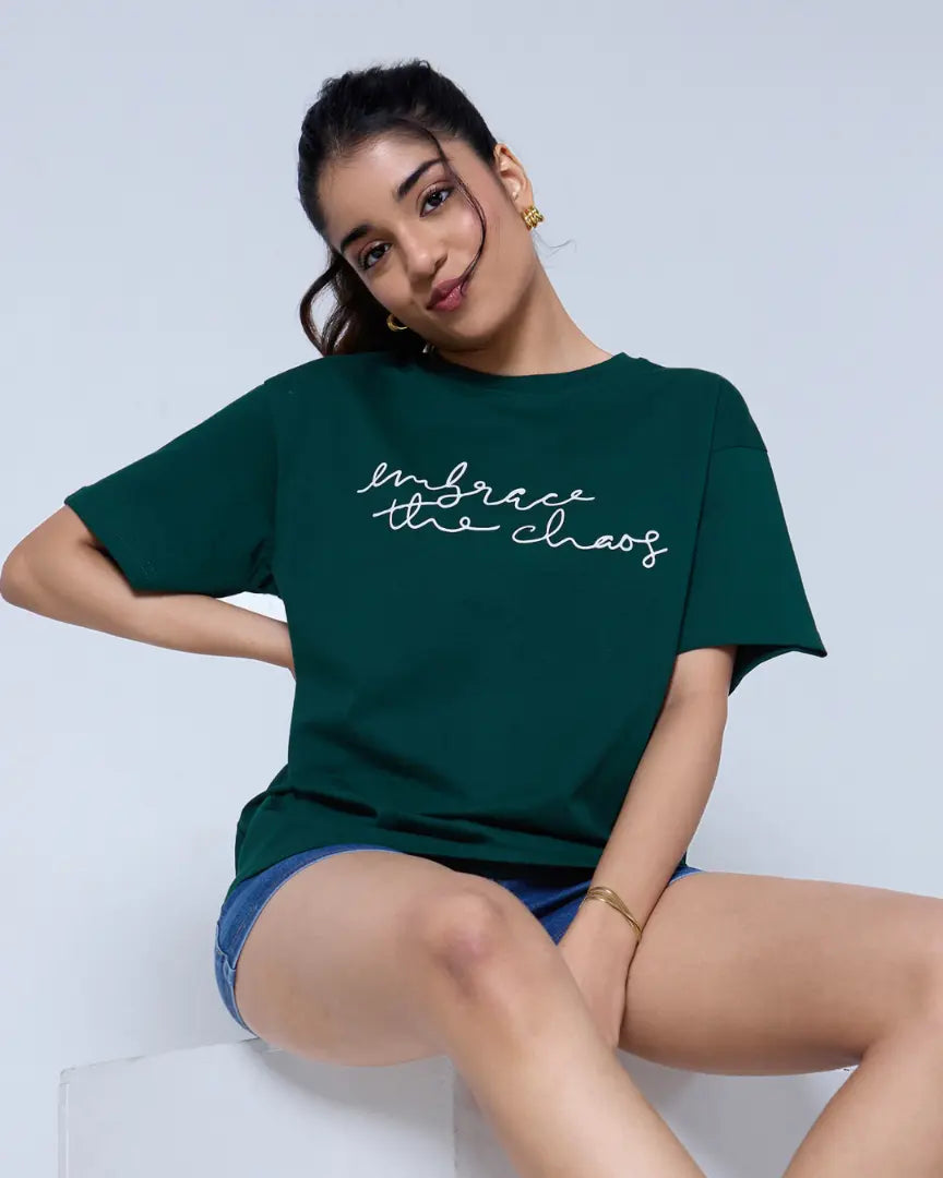 Embrace The Chaos Oversized T-Shirt – dark green oversized t-shirt with white script print, worn by model