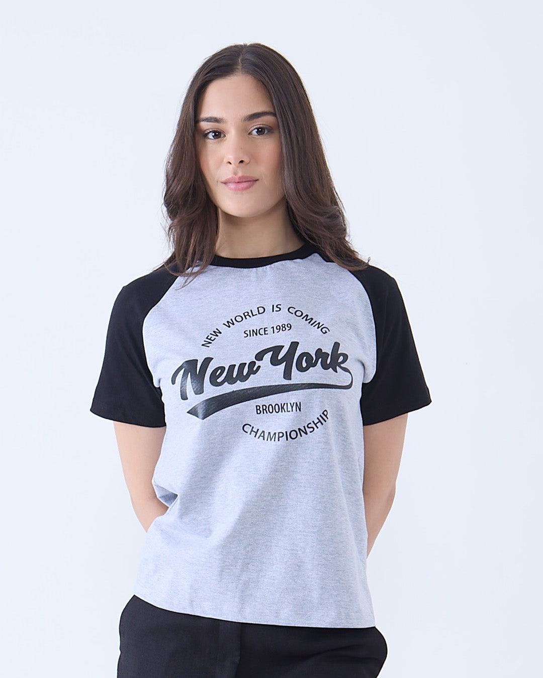 Grey New York Raglan T-Shirt by DKY – grey body with black sleeves and a New York graphic, worn by model