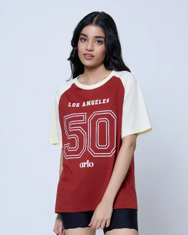 Los Angeles Raglan Oversized T-Shirt – red body with white sleeves, oversized fit, graphic 50 design, worn by model
