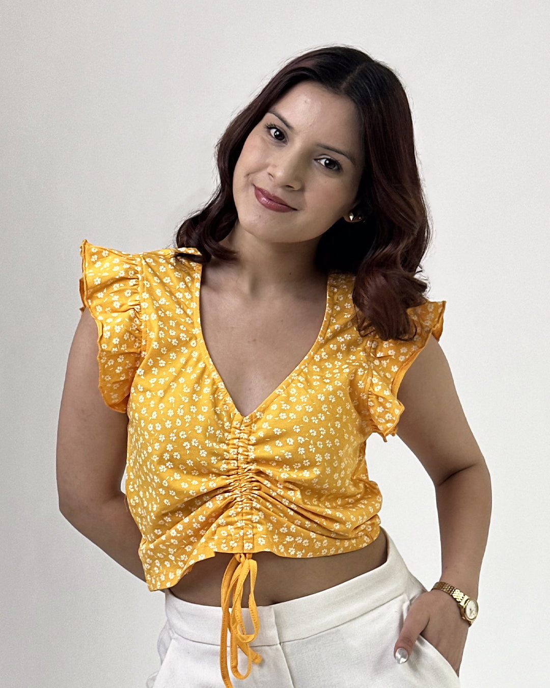 Mango Sunflower Crop Top – yellow floral ruched V-neck crop top with flutter sleeves, worn by model