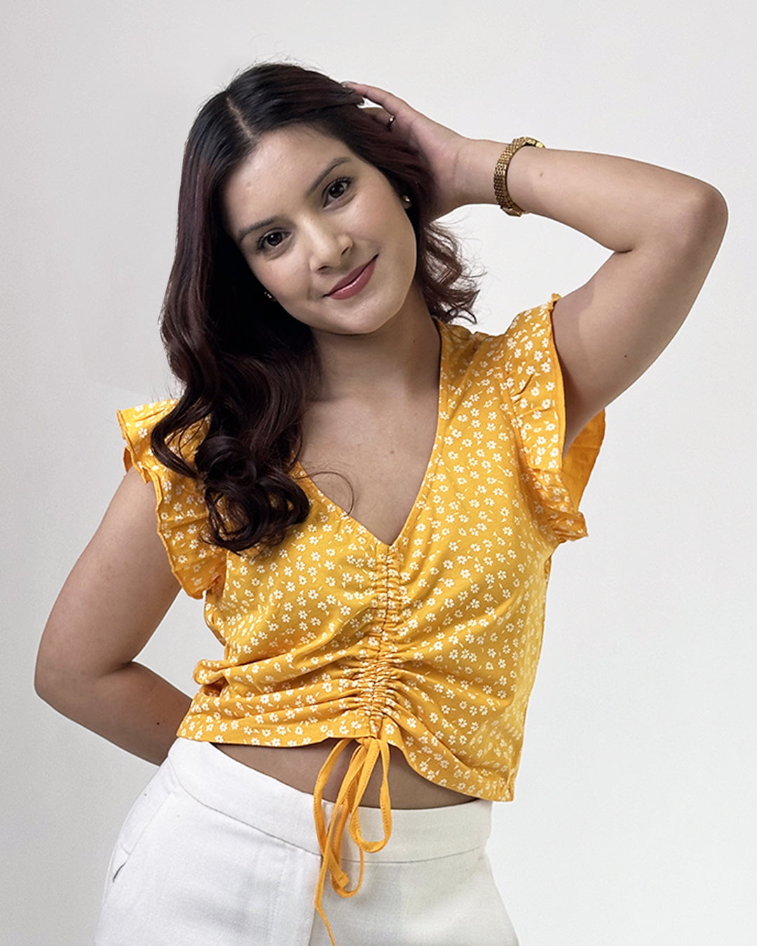 Mango Sunflower Crop Top – yellow floral print cropped top with ruched front and flutter sleeves, worn by model