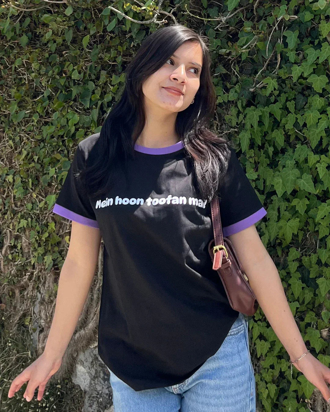 Mein Hoon Toofan Mail Tap Out T-Shirt – black regular tee with purple trim and white text, worn by model