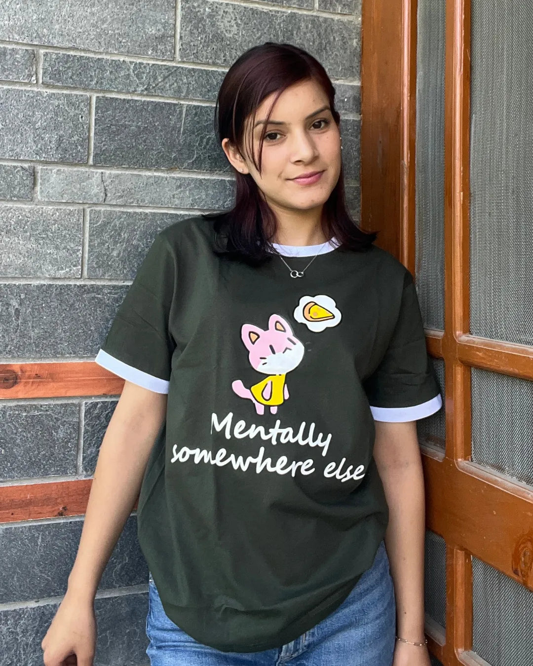 Mentally Somewhere Else Tap Out T-Shirt – dark olive oversized graphic tee with pink cat and slogan, worn by model
