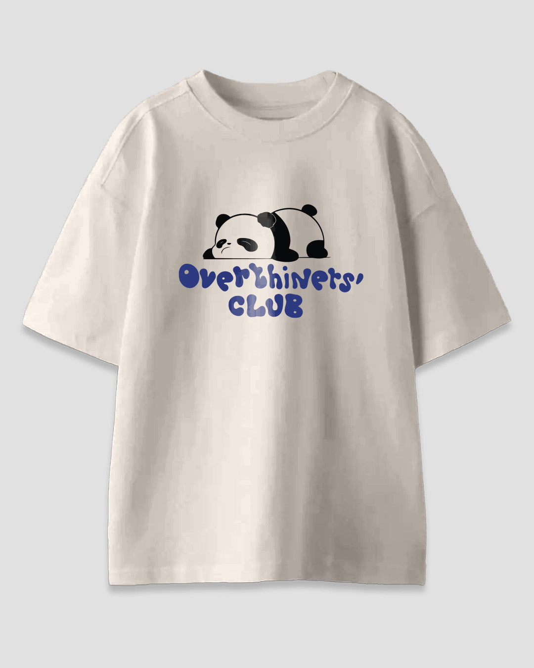 Overthinkers Club Oversized T-Shirt – cream/off-white with a panda graphic and blue text reading Overthinkers' CLUB, shown in flat lay