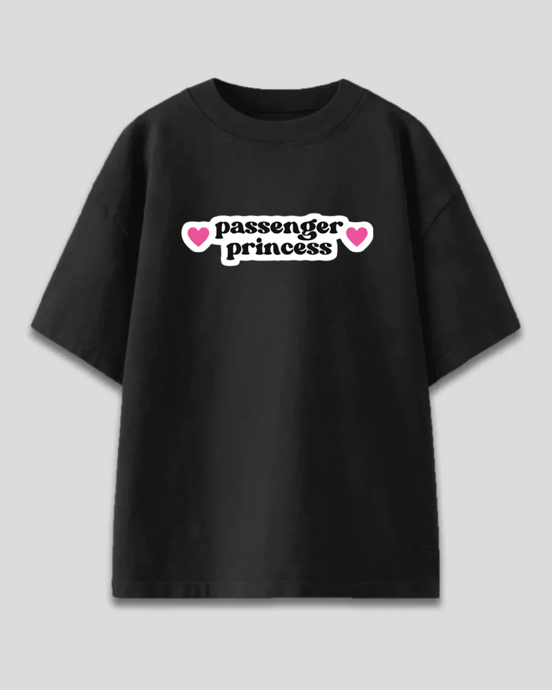 Passenger Princess Oversized T-Shirt – black oversized tee with white passenger princess graphic and pink hearts, flat lay
