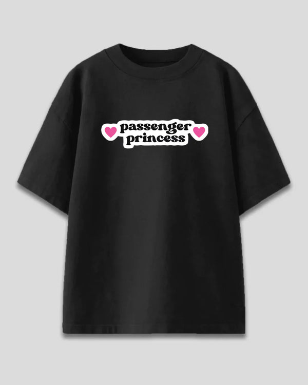 Passenger Princess Oversized T-Shirt – black oversized tee with white passenger princess graphic and pink hearts, flat lay