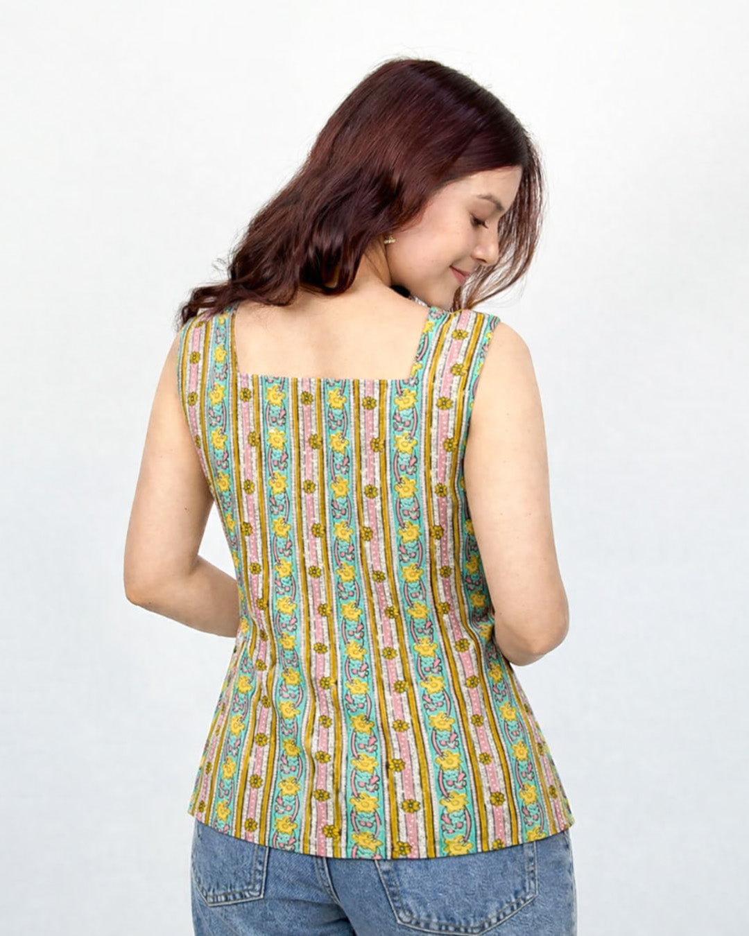 Pearl Nayra Short Kurti – multicolor printed sleeveless kurti with vertical floral stripes, worn by model.