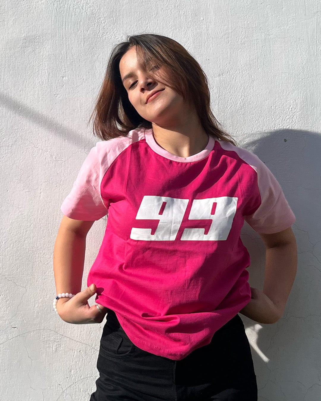 Pink 99 Raglan T-Shirt - pink body with lighter pink sleeves and white 99 graphic, worn by model.