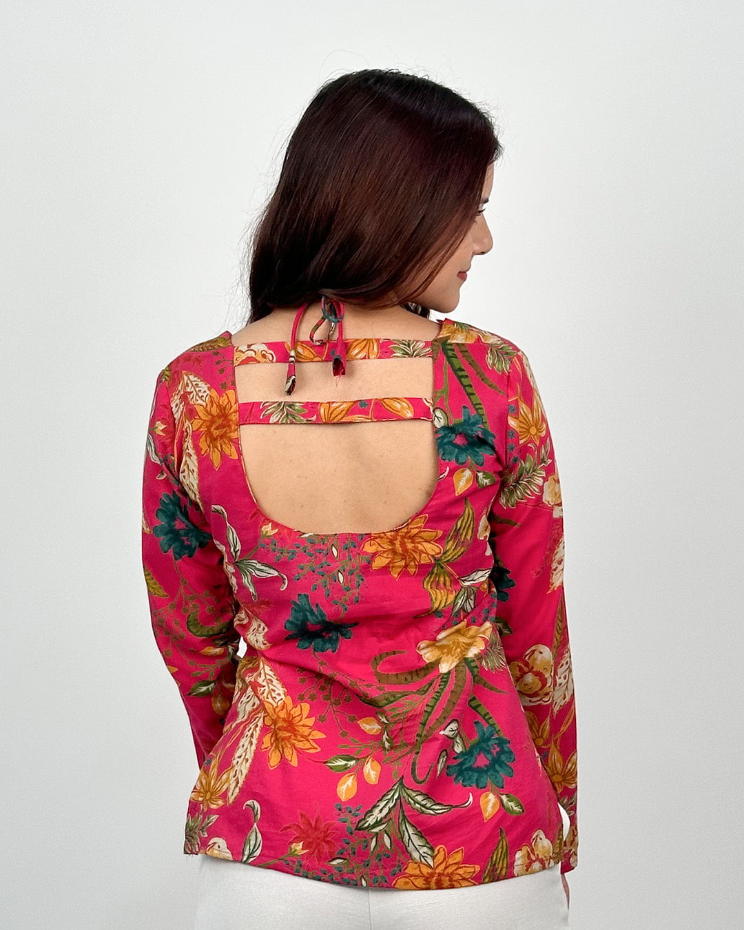 Pink Noor Short Kurti – printed floral kurti with back cutout and tie straps, worn by model