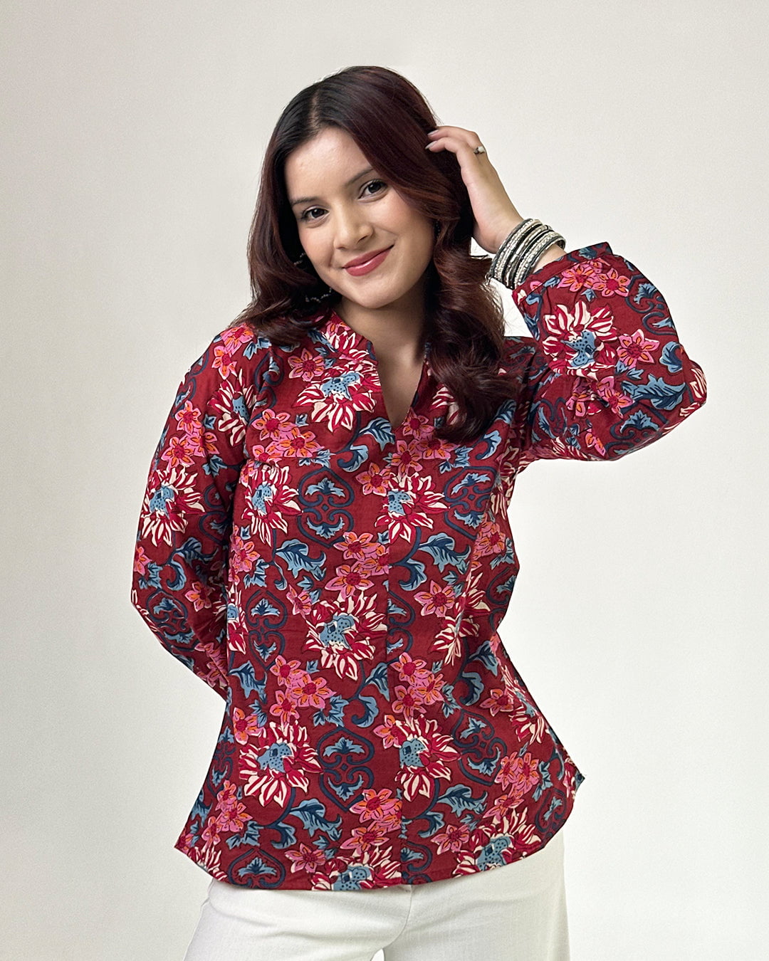 Red Vaani High Low Short Kurti – red printed floral kurti with long sleeves, worn by model in studio