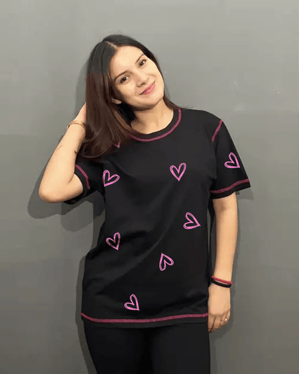 Reverse Weave Black Lover T-Shirt – black regular tee graphic with pink heart designs, worn by model in XS