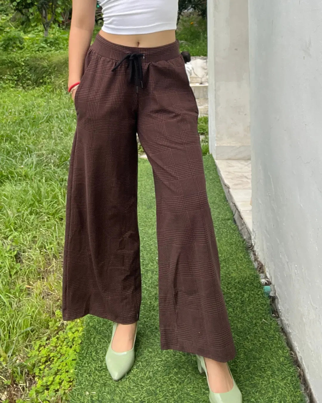 Rustic Pajama - brown plaid wide-leg pants with drawstring, worn by model in a white crop top