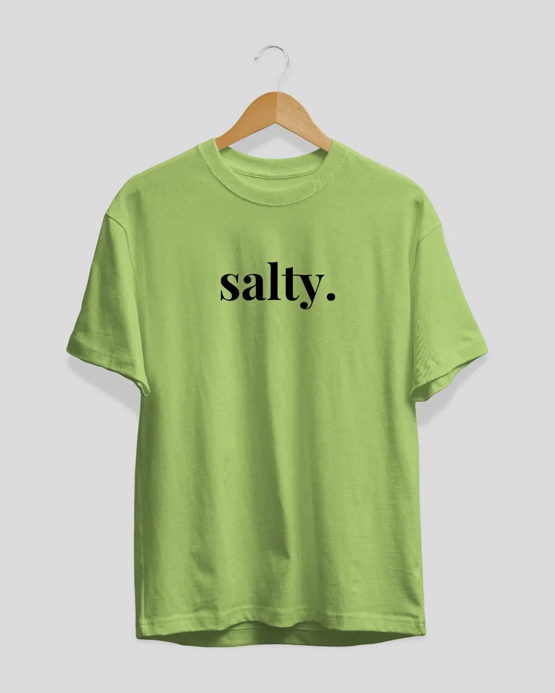 Salty T-Shirt - lime green regular tee with black salty graphic, displayed on a wooden hanger
