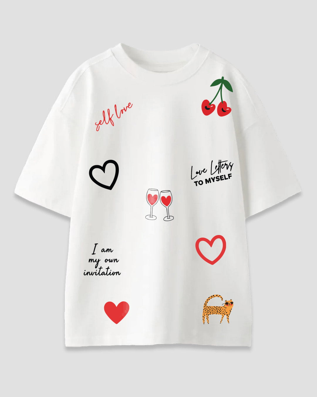 Self Care Oversized T-Shirt – white graphic tee with red hearts, cherries, wine glasses and leopard, shown in flat lay