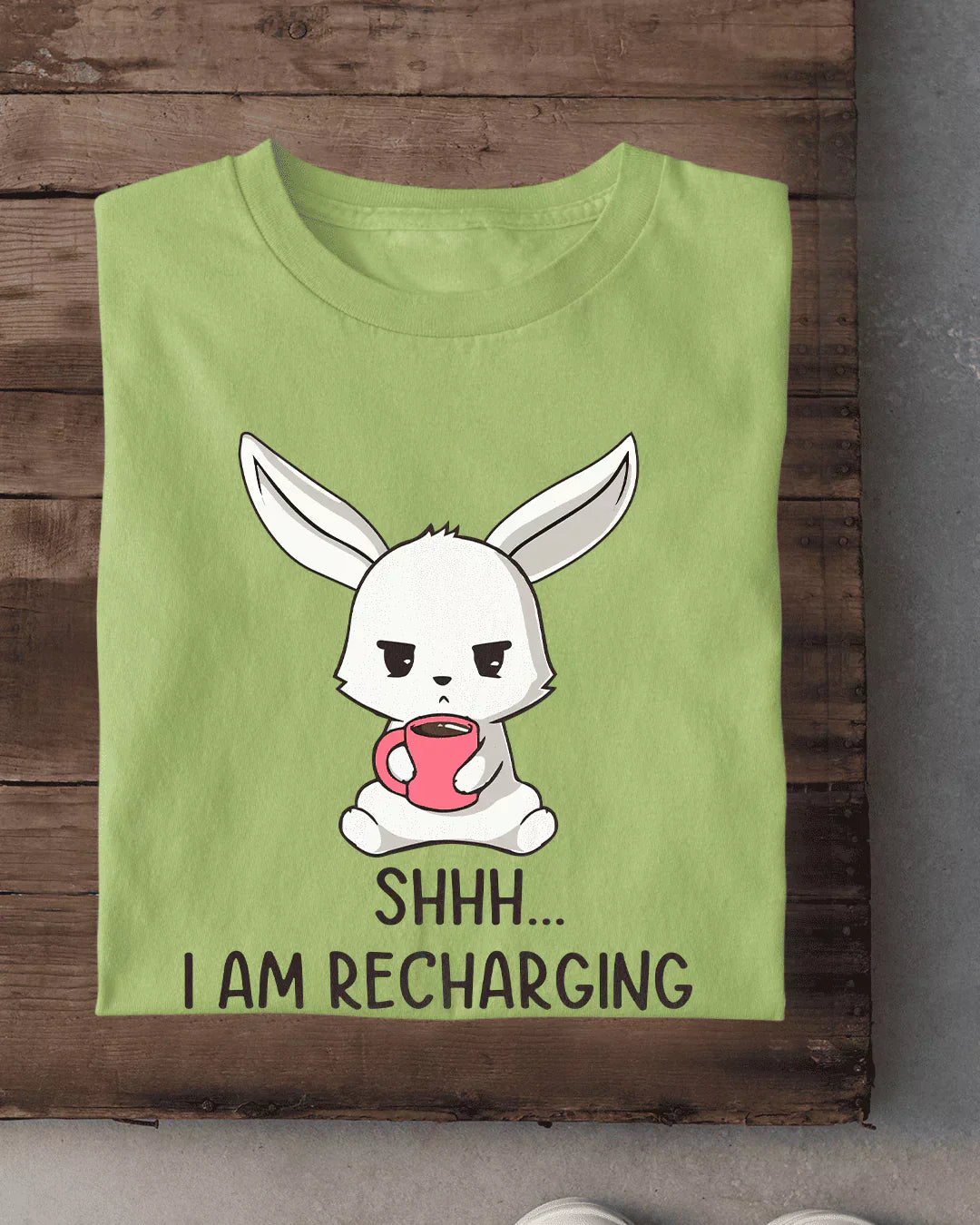 Shh I Am Recharging T-Shirt – lime green graphic tee with a cartoon bunny holding a pink mug.