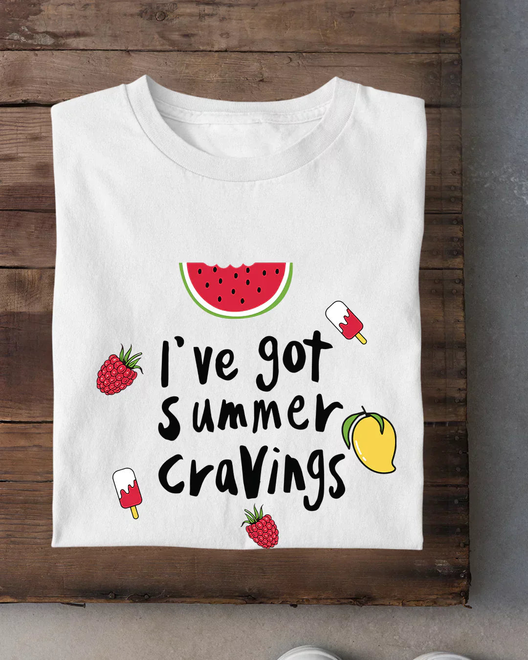 Summer Cravings T-Shirt – white DKY graphic tee with watermelon slice, raspberries, peach and popsicles, shown in flat lay