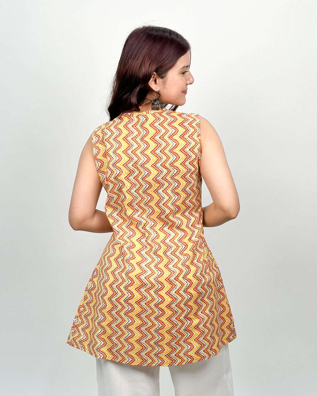 Sunset Shuffle Cotton Top yellow and orange zigzag printed sleeveless tunic with an A-line fit, worn by model