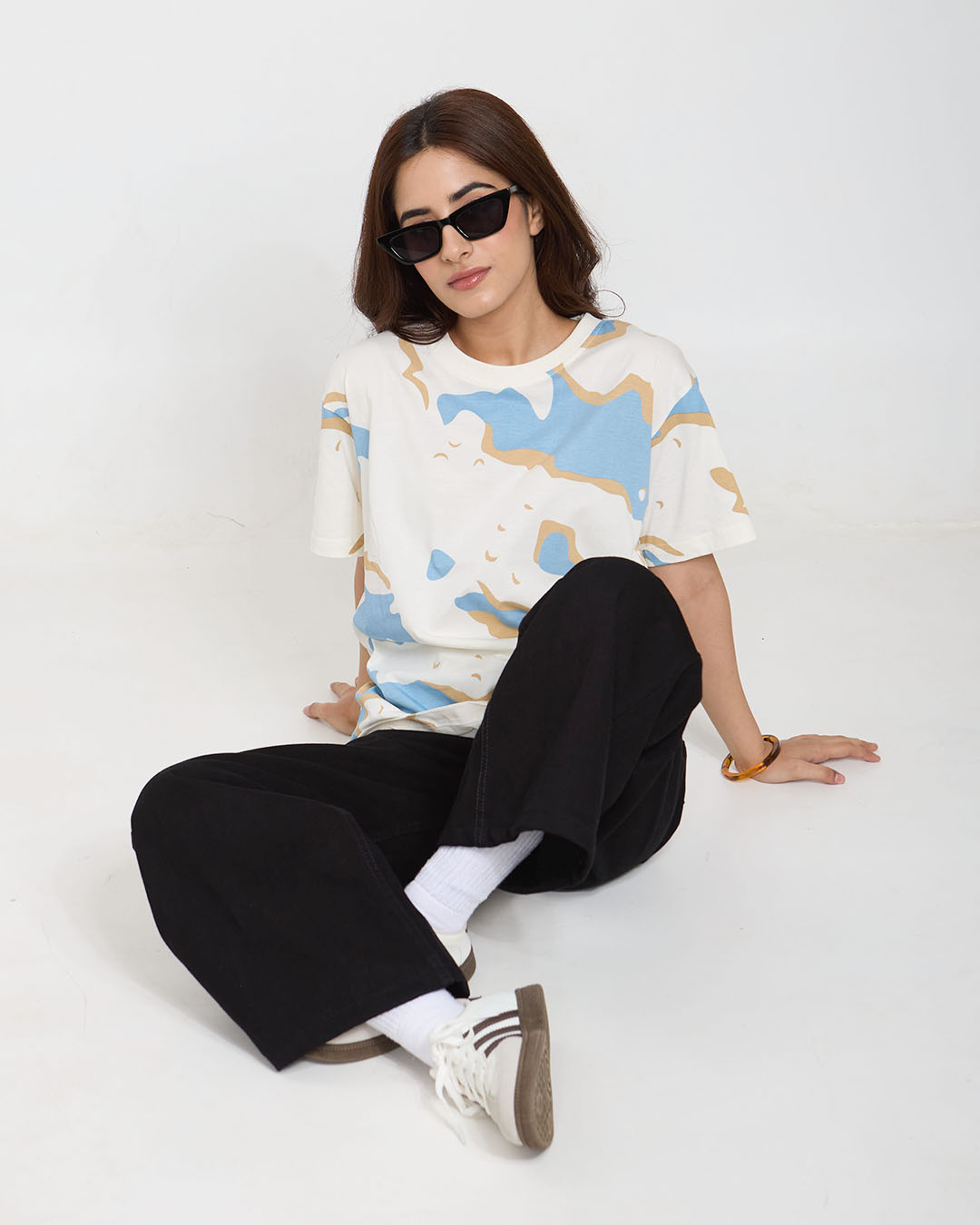 Wavy Oversized T-Shirt – white with blue and beige abstract waves, OS WS, worn by model.
