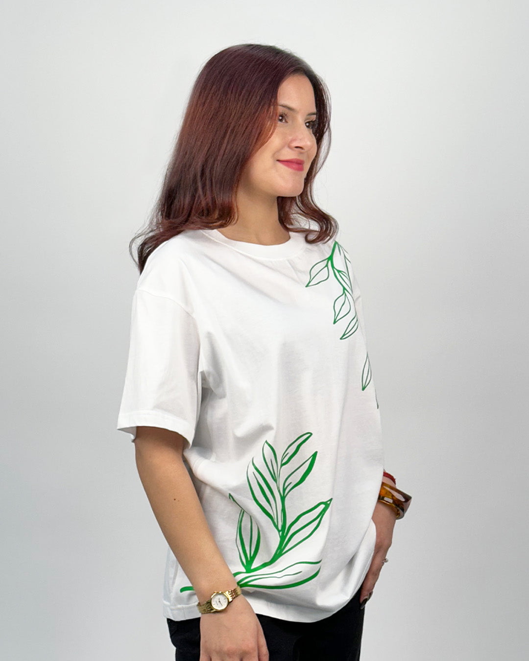 White In The Jungle Oversized T-Shirt – white oversized tee with green leaf graphics, worn by model