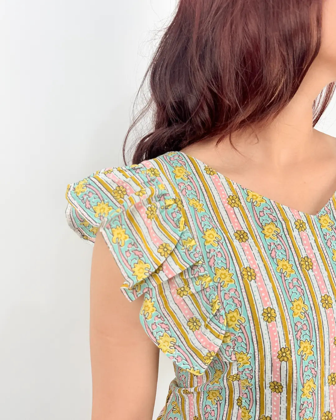 White Laila Ruffle Short Kurti – pastel striped floral print with ruffle sleeves, worn by model