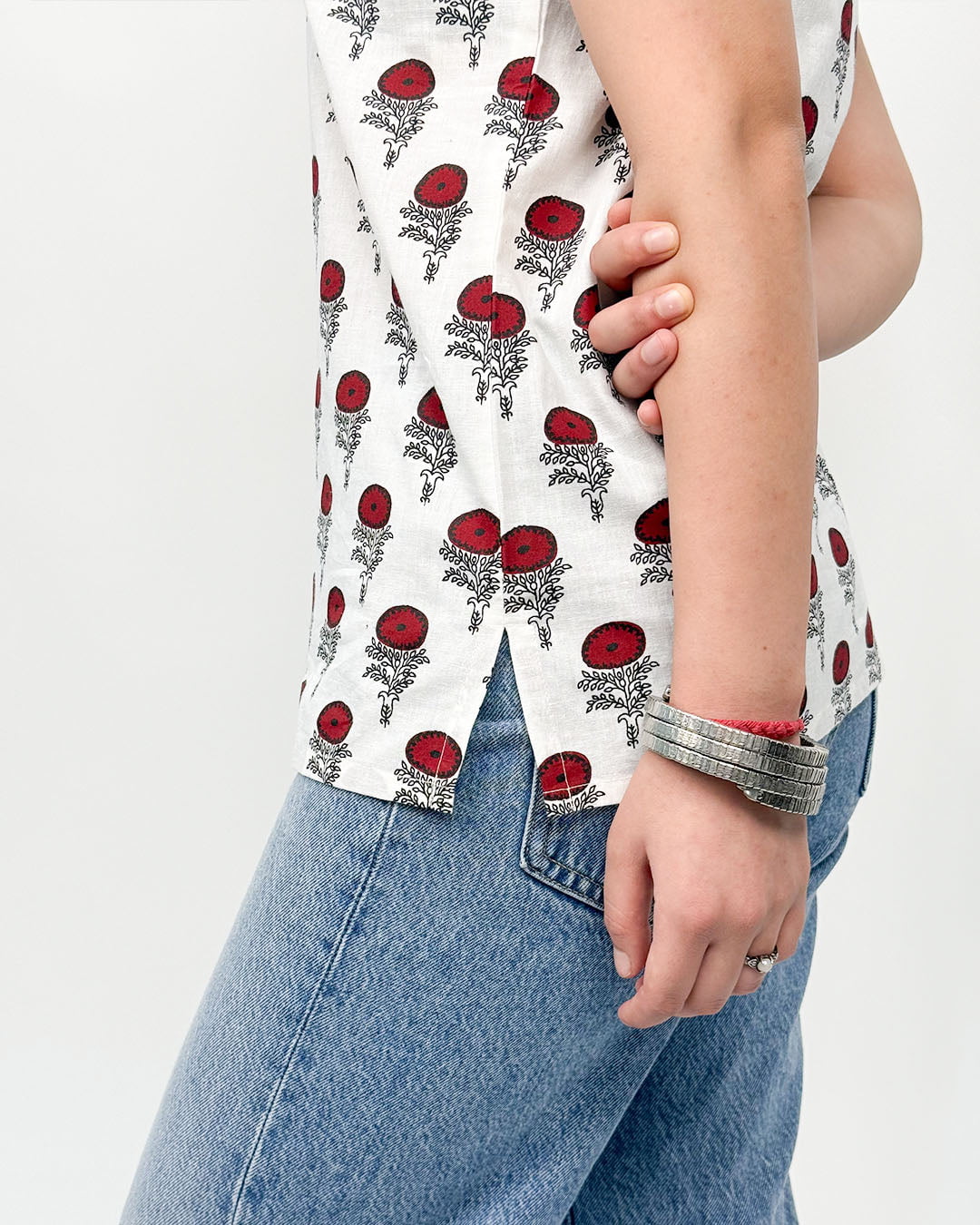 White Nayra Short Kurti – white relaxed-fit kurti with red floral print, worn by model