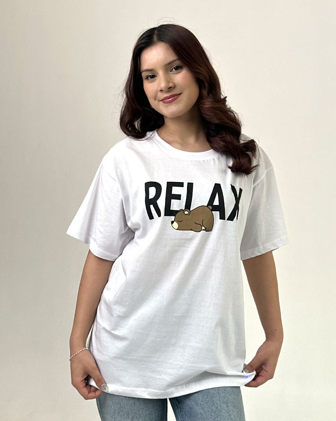 White Relax Oversized T-Shirt featuring RELAX text and bear graphic, worn by model