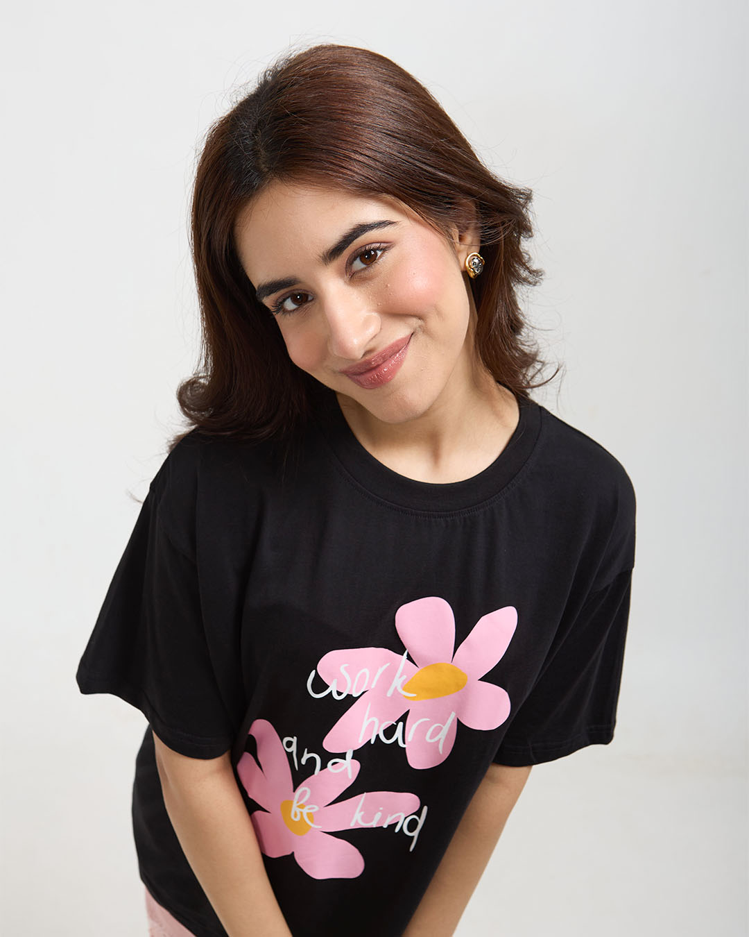 Work Hard And Be Kind Oversized T-Shirt - black graphic tee with pink flowers and white script, worn by model
