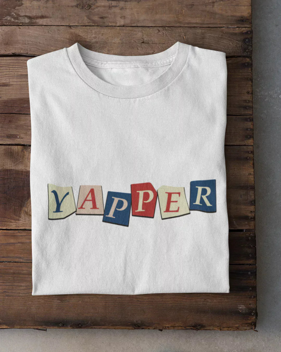 Yapper T-Shirt - white regular tee with colorful YAPPER letter tiles graphic, shown in flat lay